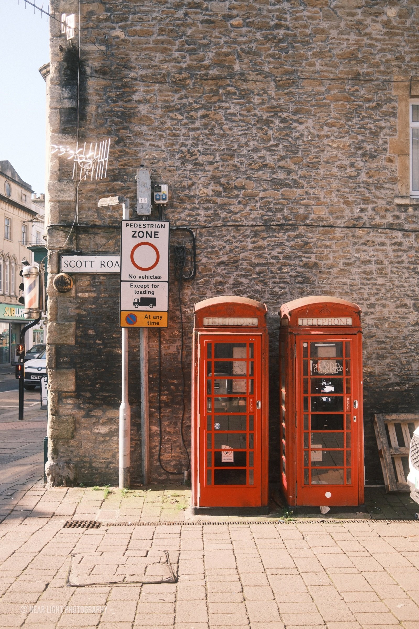 Red phone boxes on a street