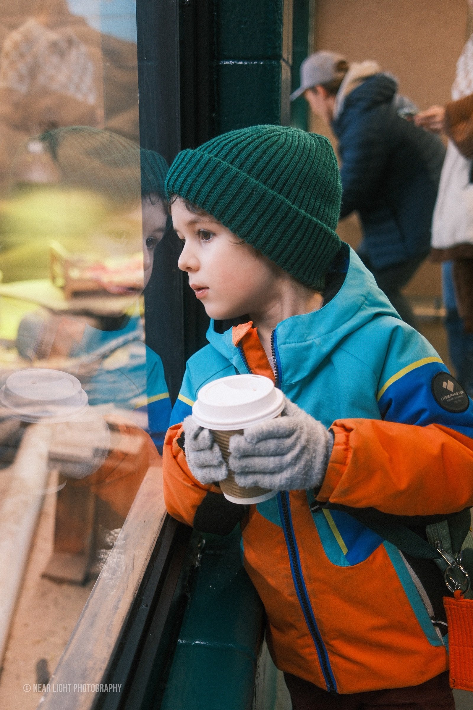 Child portrait through cafe glass